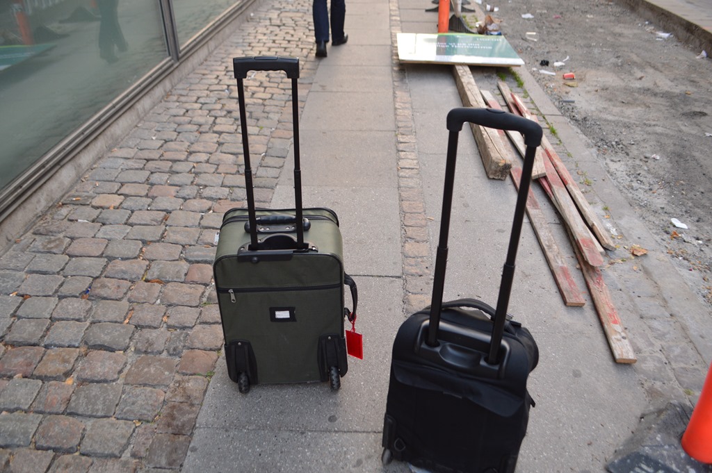 two luggage on the sidewalk