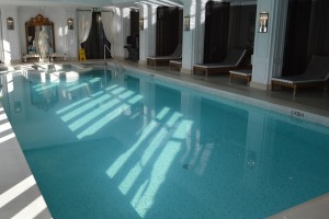 a swimming pool with chairs and a window