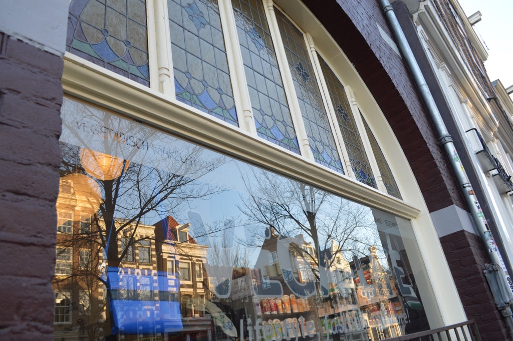 a window with a reflection of buildings in it