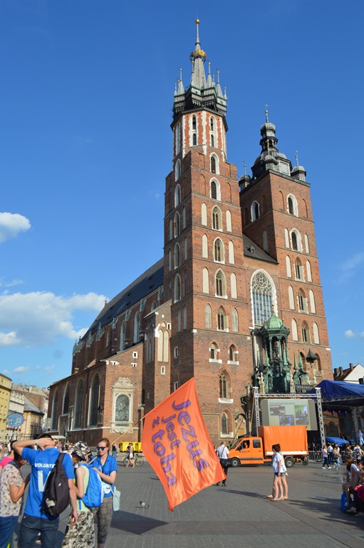 a large brick building with a large orange sign