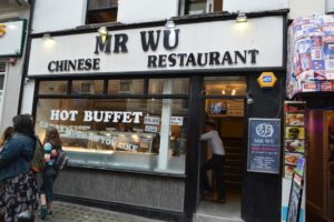 a restaurant with a sign on the front