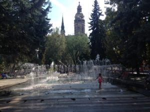 a girl playing in a fountain