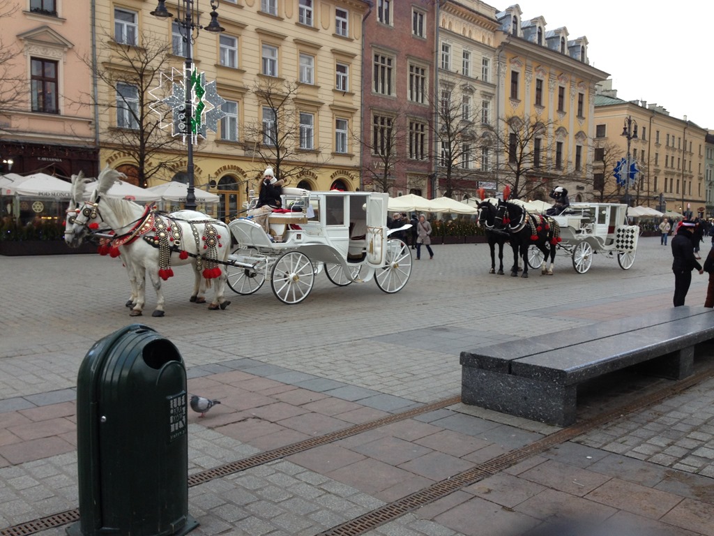 a horse drawn carriage with horses and people on it