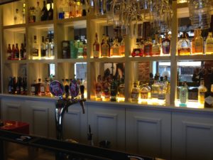 a bar with shelves full of liquor