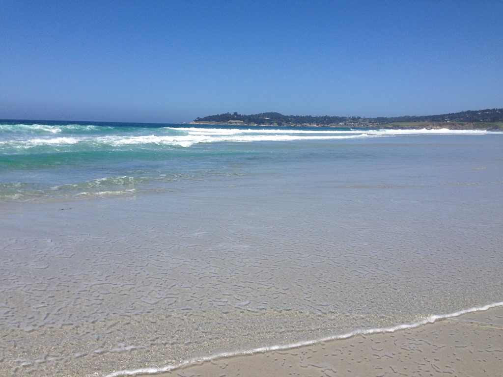 a beach with waves crashing on the sand