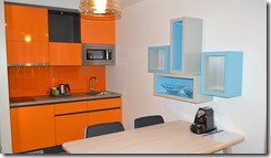 a kitchen with orange cabinets and a table