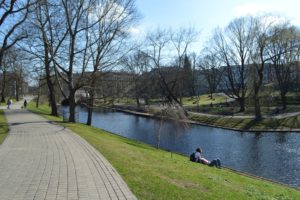 a person sitting on the side of a river