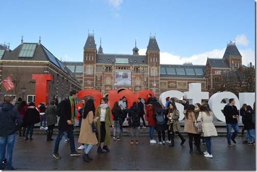 a group of people standing in front of Rijksmuseum