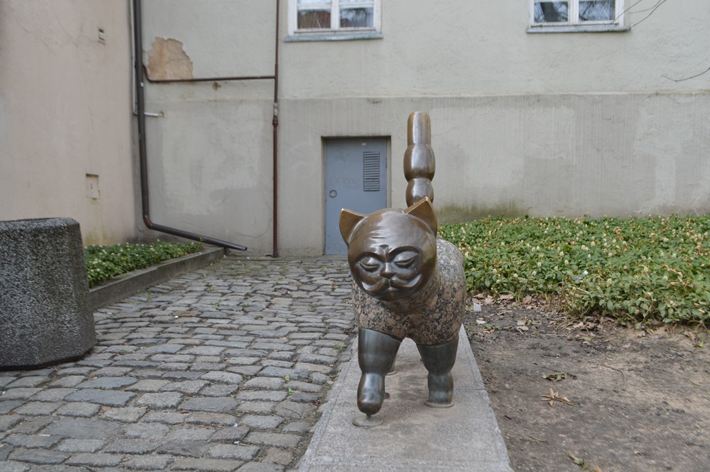 a statue of a cat on a stone path