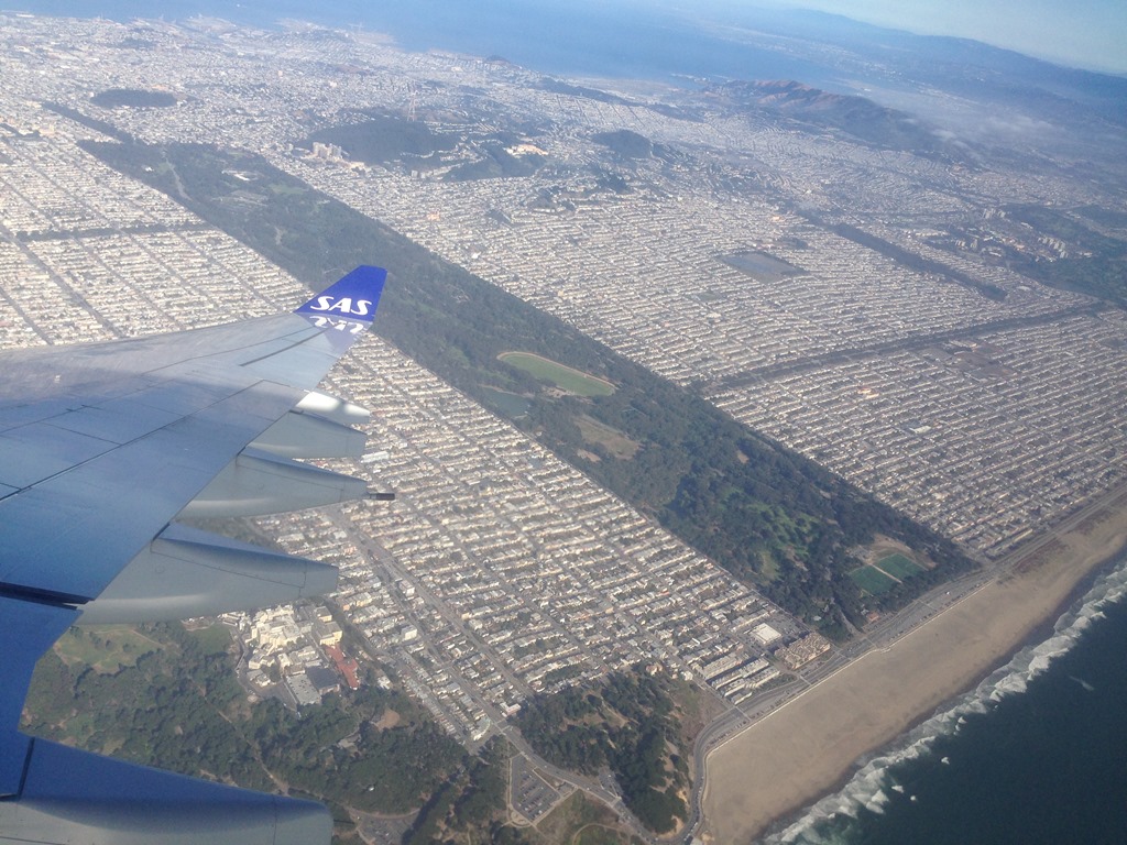 an airplane wing above a city
