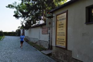 a woman running on a cobblestone road