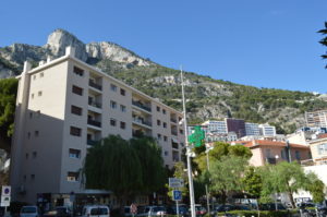 a building with trees and mountains in the background
