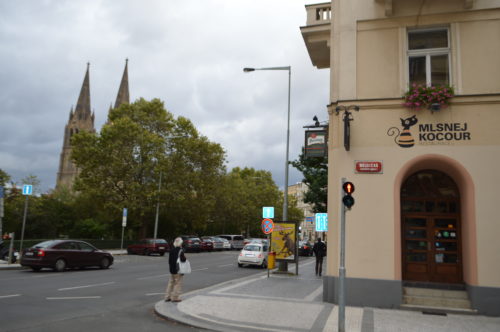 a street corner with cars and a building