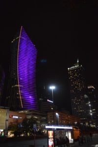 a tall building with purple lights