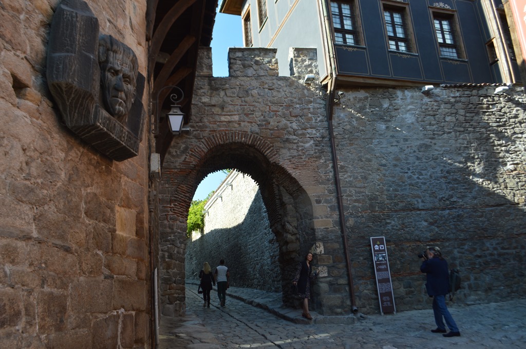 a stone archway with a face on the side of it