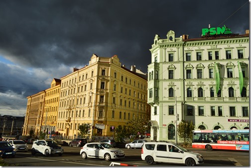 a group of buildings with cars on the street