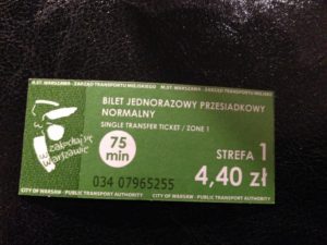 a green ticket on a black surface