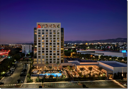 a building with a pool and parking lot