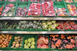 a shelf of produce in a grocery store