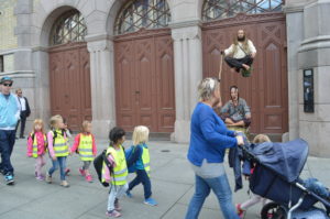 a group of children walking on a sidewalk