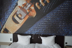 a bed with pillows and a picture of a belt