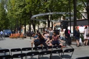 a group of people dancing in a park