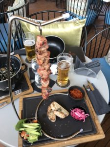 a skewer of meat and vegetables on a table