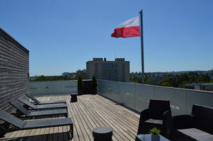 a deck with chairs and a flag on top