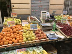 a fruit stand with a price tag