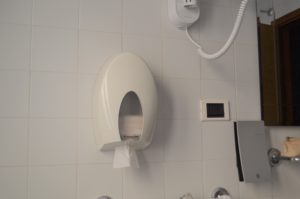 a white plastic box with a white object on the wall