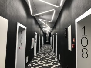 a hallway with white doors and black walls