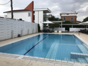 a swimming pool with a white fence