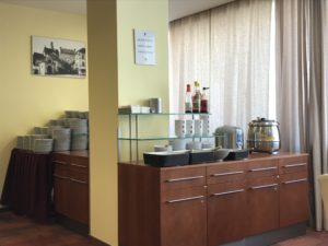 a counter with a shelf and a sign