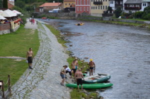 a group of people on a river bank