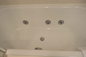 a white bathtub with silver fixtures