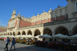 a building with many arches and people walking in front of it