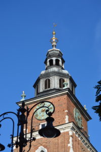 a clock tower with a cross on top