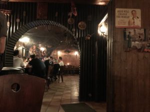 a group of people sitting at tables in a restaurant