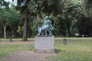 a statue of a man sitting on a bench