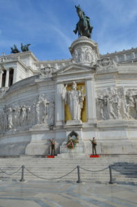 a white building with statues on the top