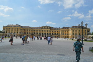 a large building with many people walking around with Schönbrunn Palace in the background