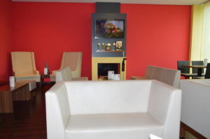 a room with white couches and red walls