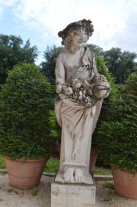 a statue of a woman holding a basket of fruit