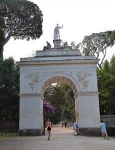 a stone archway with a statue on top