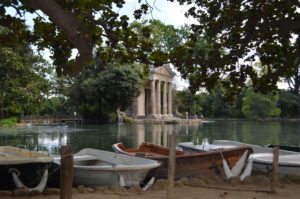 boats on the water with a building in the background