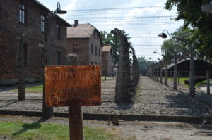 a sign in front of a fence