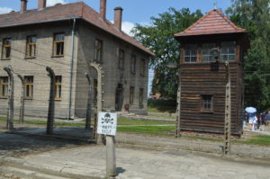 a sign on a post next to Auschwitz concentration camp