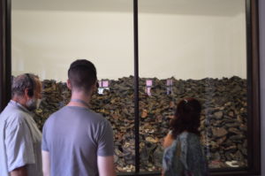 a man and woman looking at a glass wall