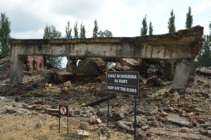 a sign on a sign next to a destroyed building