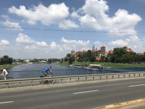 a man riding a bike on a bridge over a body of water